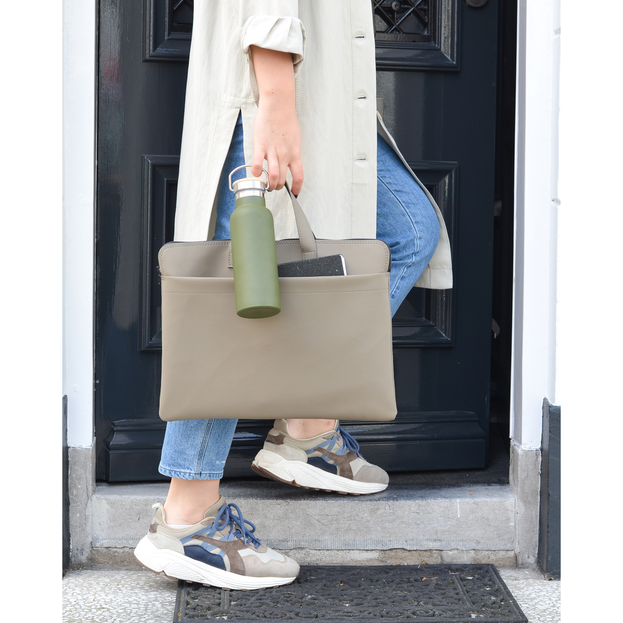 Frau mit Sneakers und Trinkflasche trägt hellgraue Laptoptasche – ideal für Büro, Freizeit oder Coworking