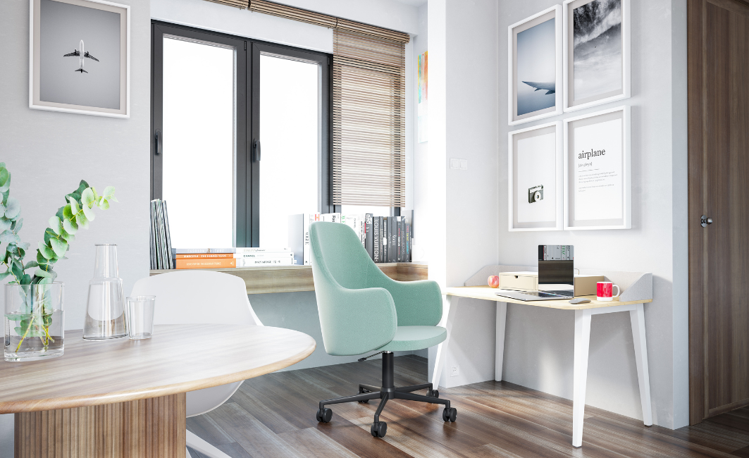 Heller Arbeitsbereich mit mintgrünem Stuhl, weißem Tisch und großen Fenstern, dekoriert mit Bildern an der Wand.