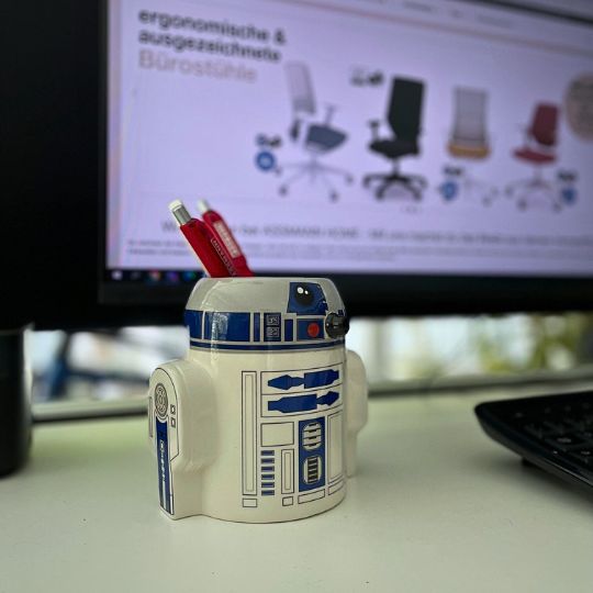 Stifteköcher in Form von R2-D2 vor einem Computermonitor